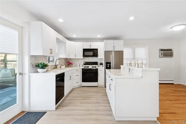 a kitchen with white cabinets and white appliances