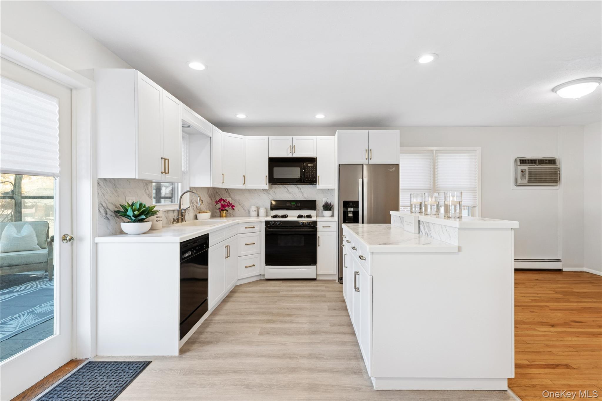 154-27 20th Road Queens, NY 11357 - Photo 9 of 30 a kitchen with white cabinets and white appliances