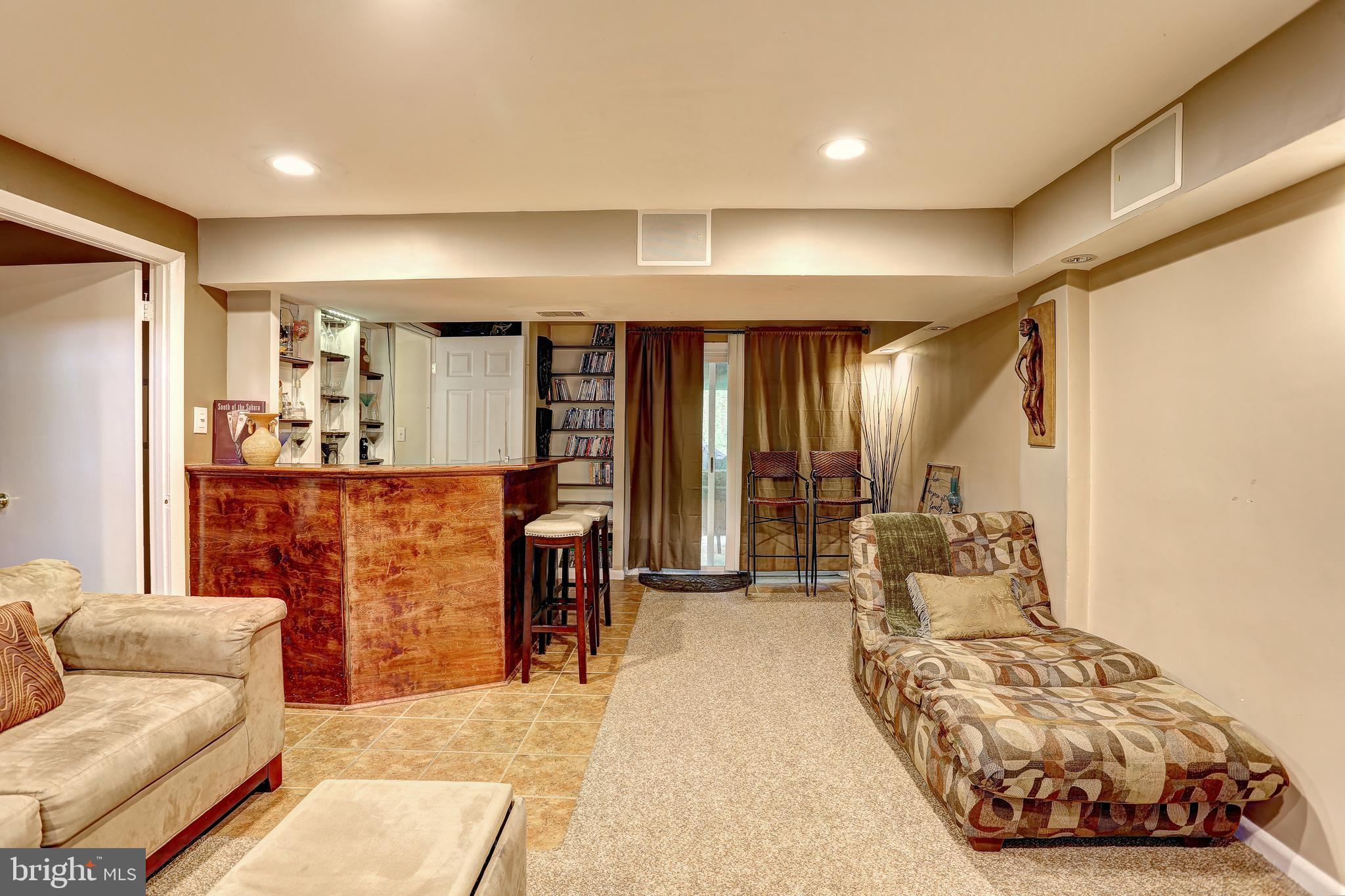 5401 Lightning View Road Columbia, MD 21045 - Photo 23 of 36 Lower Level Recreation Room, Bar, Opens to Patio