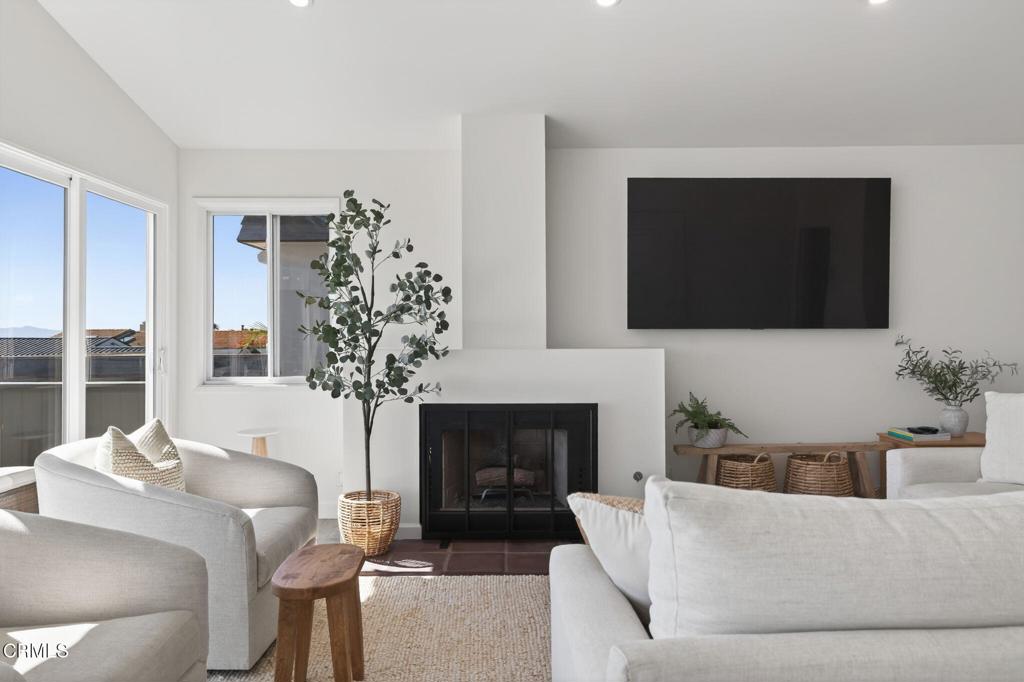 4229 Faria Road Ventura, CA 93001 - Photo 13 of 47 a living room with furniture a fireplace and a flat screen tv