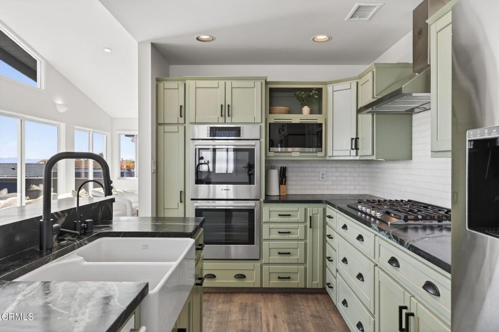 4229 Faria Road Ventura, CA 93001 - Photo 17 of 47 a kitchen with granite countertop a sink a stove and cabinets