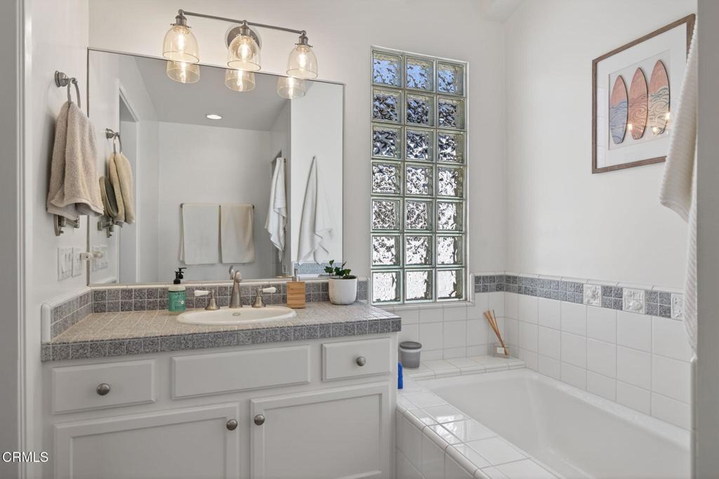 4229 Faria Road Ventura, CA 93001 - Photo 24 of 47 a bathroom with a granite countertop tub sink and mirror