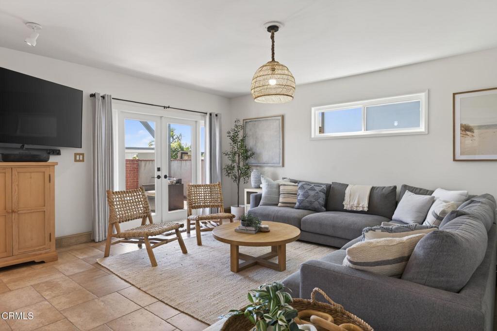 4229 Faria Road Ventura, CA 93001 - Photo 6 of 47 a living room with furniture a flat screen tv and kitchen view