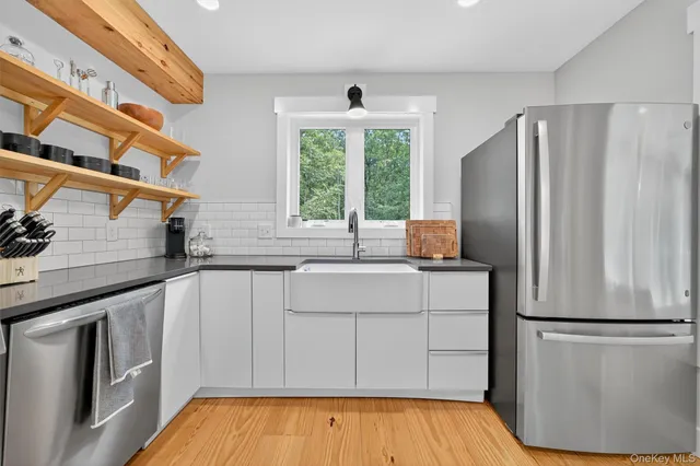 a kitchen with a refrigerator and a sink