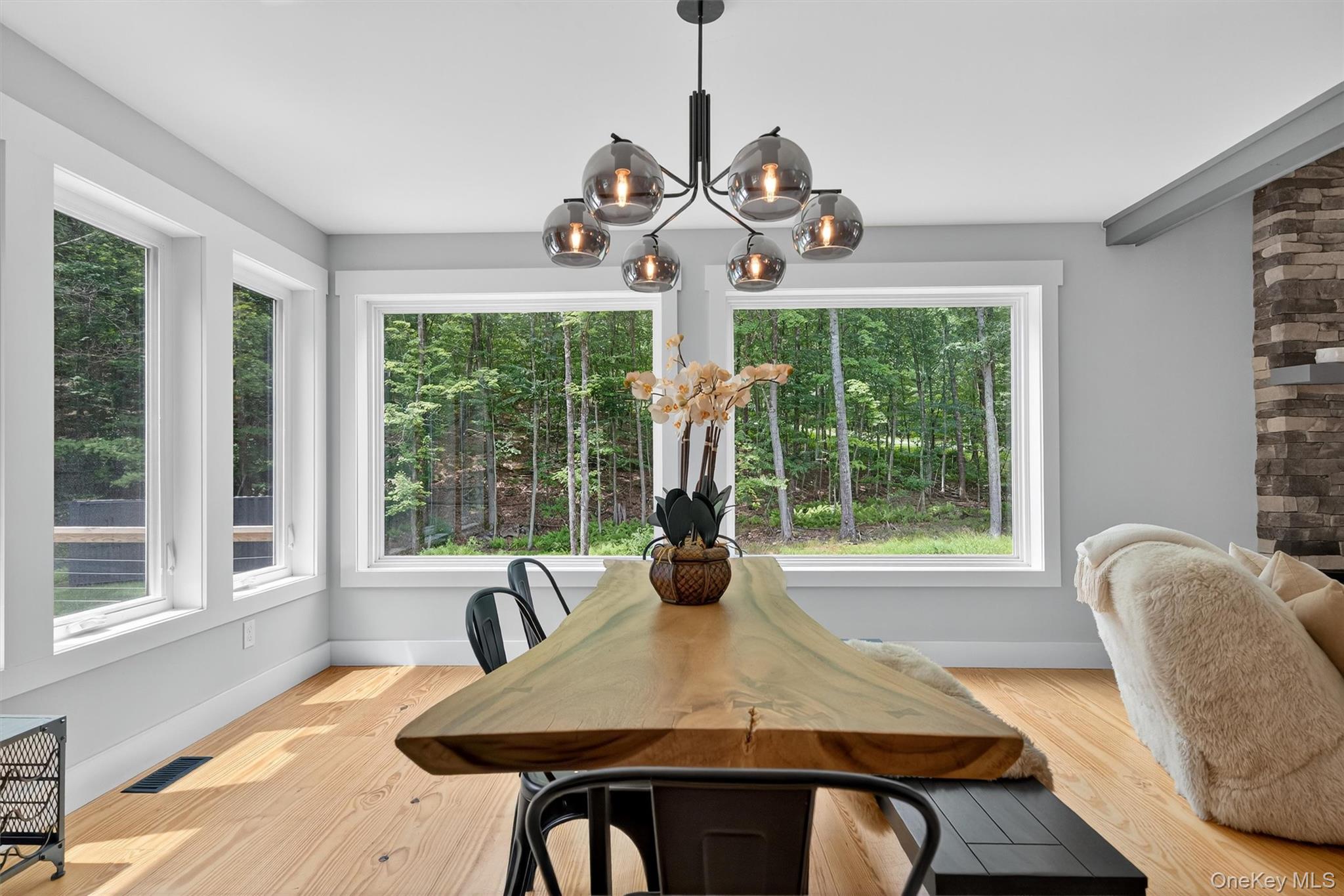 107 Maple Lane Narrowsburg, NY 12764 - Photo 19 of 49 a view of a dining room with furniture wooden floor and chandelier