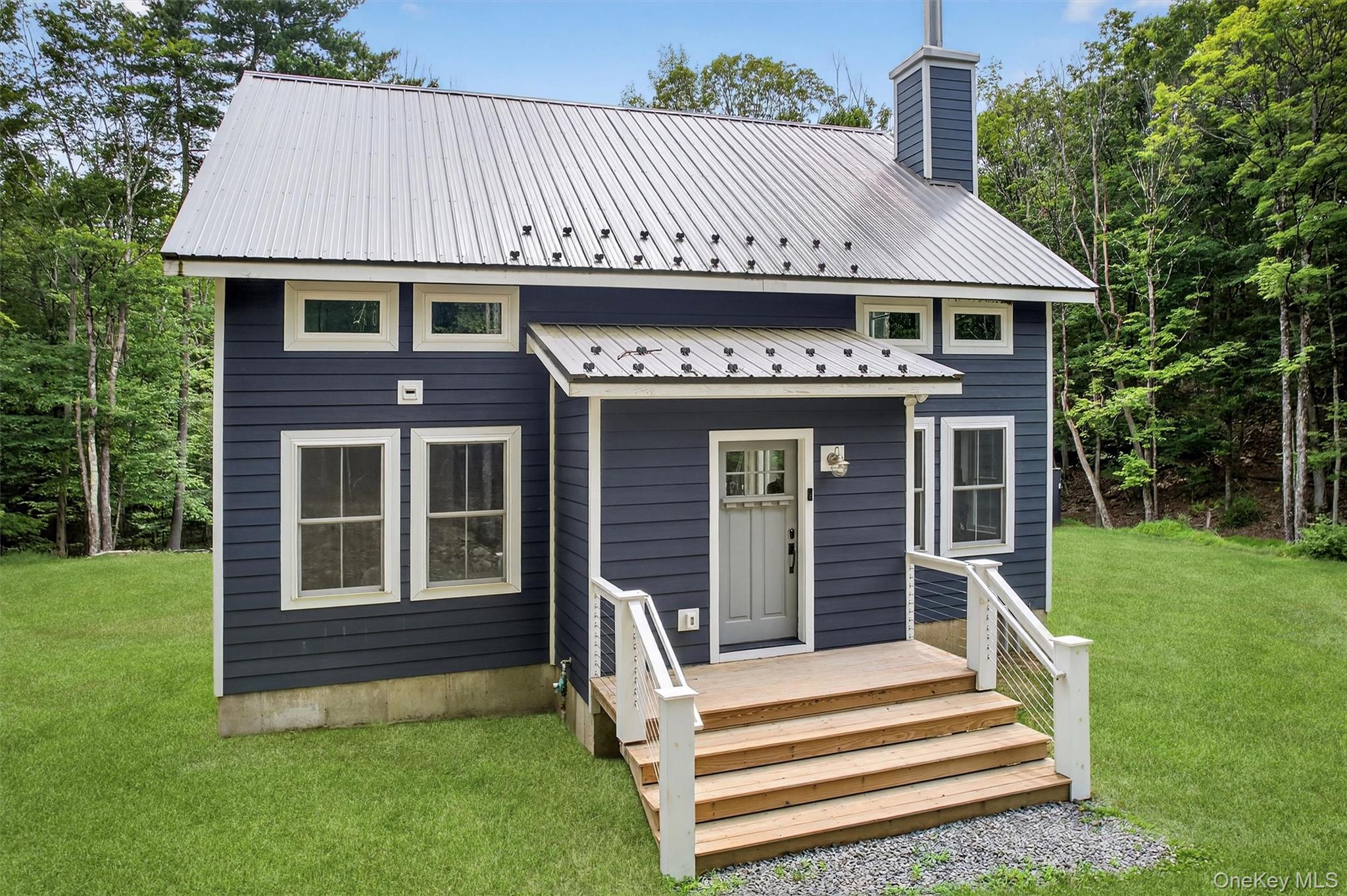107 Maple Lane Narrowsburg, NY 12764 - Photo 2 of 49 a front view of a house with a garden