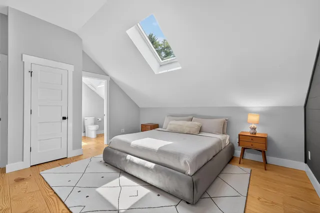 a bedroom with a bed and a table