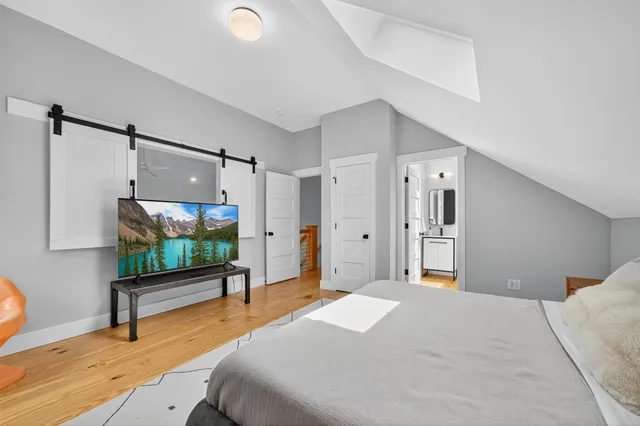 a bedroom with a bed and a flat screen tv