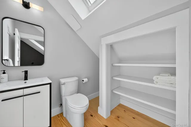 a bathroom with a toilet sink and mirror