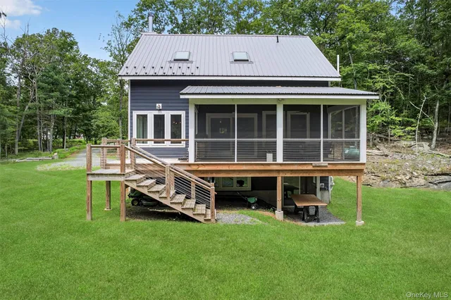 a view of a house with a yard and sitting area