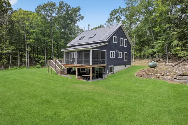 a view of an house with backyard porch and sitting area