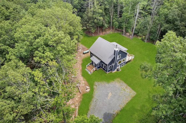 an aerial view of a house with backyard