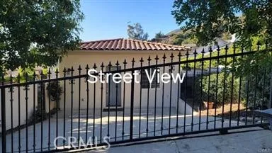 a view of staircase with railing and white walls