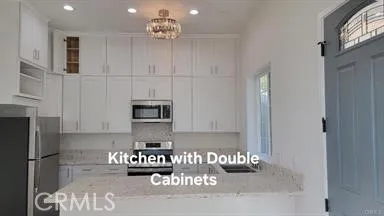 a kitchen with a refrigerator and a stove top oven