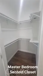 a empty closet with a wooden floor