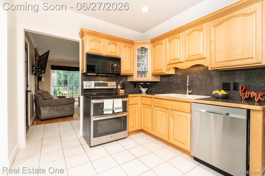 1222 Kings Cove Court, Unit 244 Rochester, MI 48306 - Photo 12 of 44 Kitchen features tile floors & Natural Wood Cabinets