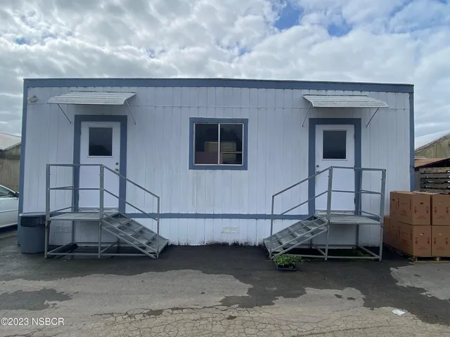 a view of garage with a car parked in it
