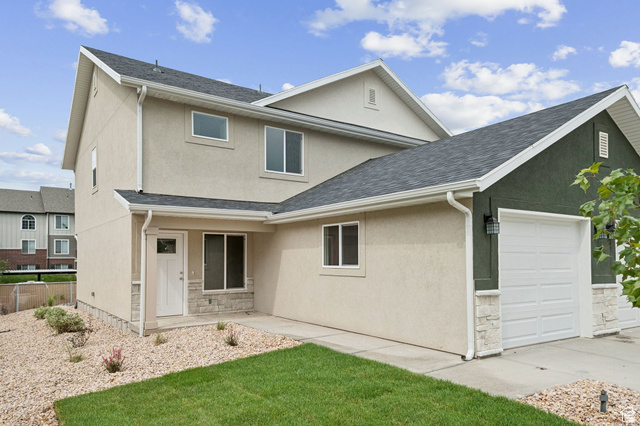 1615 North Angel Street West Layton, UT 84041 - Photo 1 of 22 View of front facade featuring stucco siding, an attached garage, roof with shingles, a front lawn, and stone siding