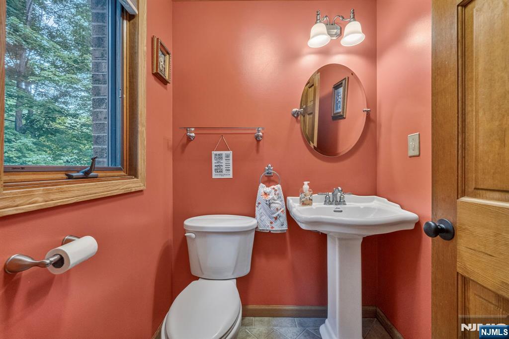 5110 Berkshire Valley Road Oak Ridge, NJ 07438 - Photo 6 of 49 a bathroom with a toilet sink and mirror