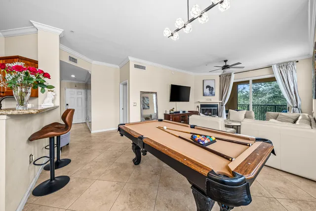 a living room with furniture a flat screen tv and a potted plant