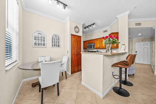 a view of a dining room with furniture and a chandelier