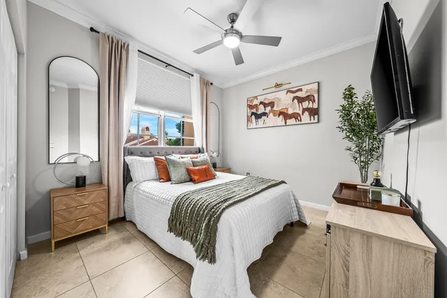 a bedroom with bed and a flat screen tv