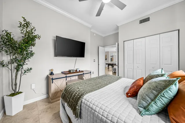 a bedroom with a bed and a flat screen tv