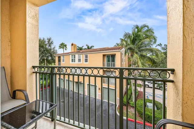 a view of a balcony with a plants and trees