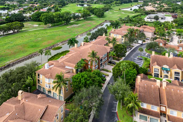 an aerial view of a house with a garden and lake view