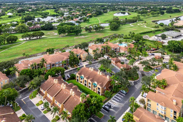 an aerial view of residential houses with outdoor space and street view