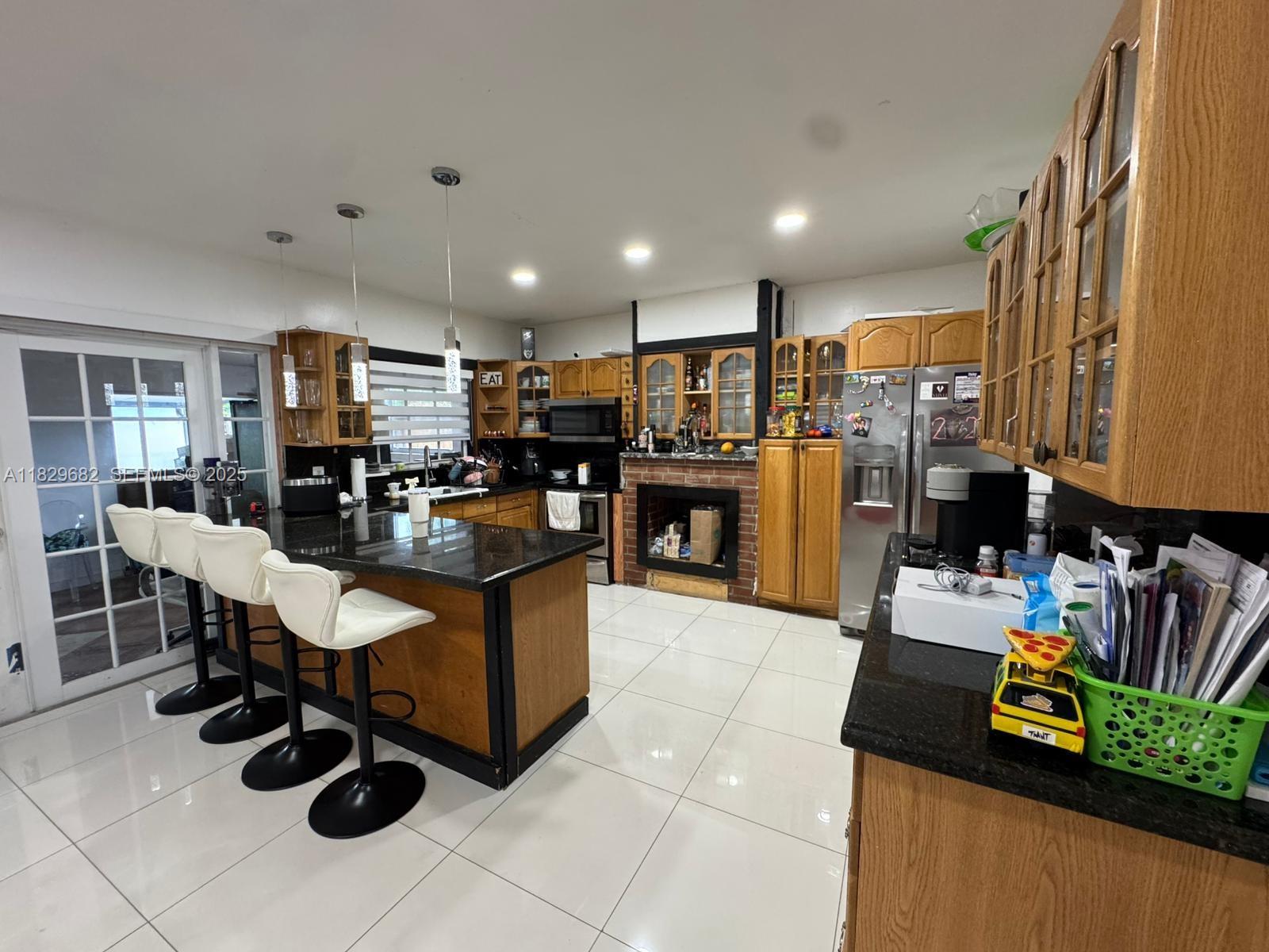 12841 Southwest 54th Street, Unit 1 Miami, FL 33175 - Photo 11 of 15 a living room with stainless steel appliances kitchen island granite countertop furniture and a view of kitchen