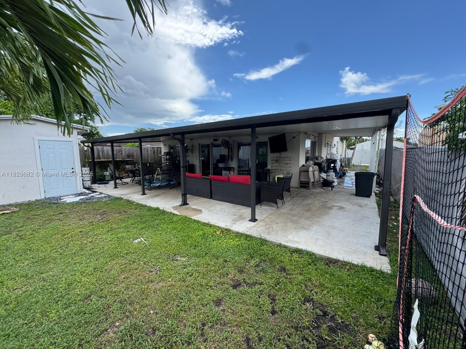 12841 Southwest 54th Street, Unit 1 Miami, FL 33175 - Photo 13 of 15 a view of living room with patio and garden