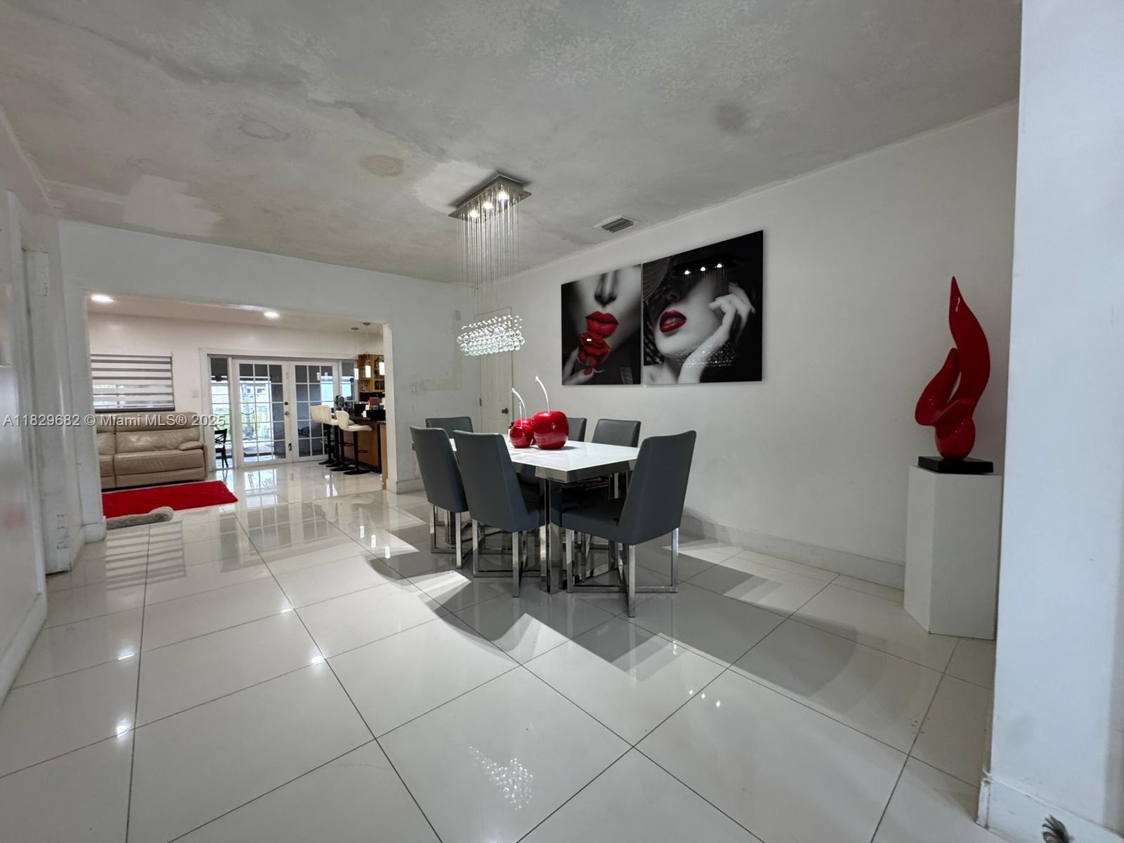 12841 Southwest 54th Street, Unit 1 Miami, FL 33175 - Photo 3 of 15 a dinning table and chairs in a room