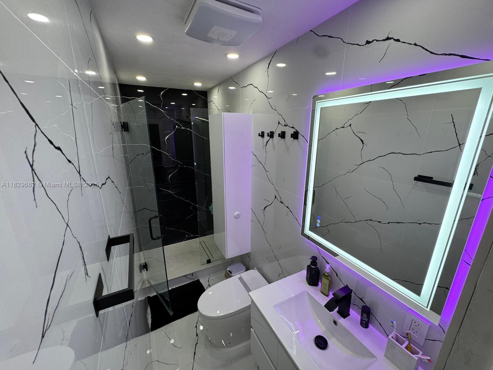 12841 Southwest 54th Street, Unit 1 Miami, FL 33175 - Photo 4 of 15 a bathroom with a sink vanity and shower