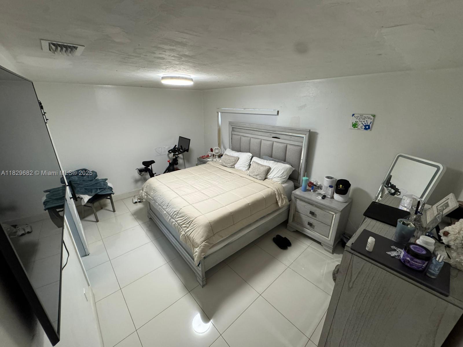 12841 Southwest 54th Street, Unit 1 Miami, FL 33175 - Photo 10 of 15 a bedroom with a bed and a dresser