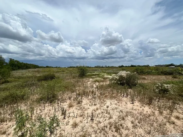 a view of a lake with houses in the back