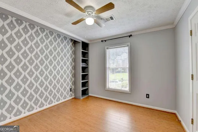 an empty room with windows and closet