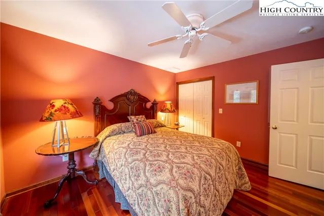 a bed sitting in a room next to a lamp