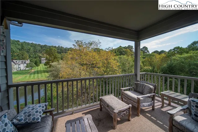 a view of a chair and tables in the balcony