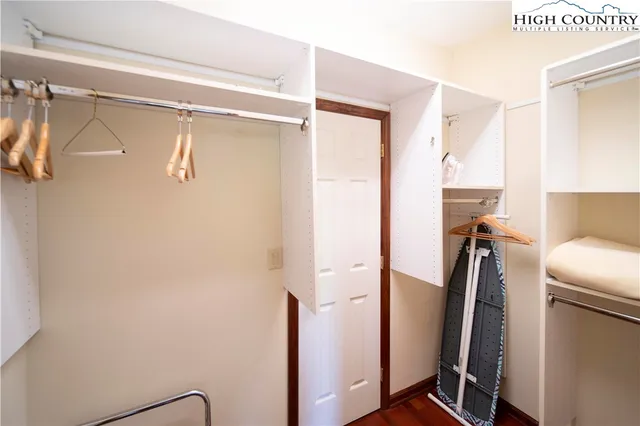 a view of walk in closet with clothes and shoes