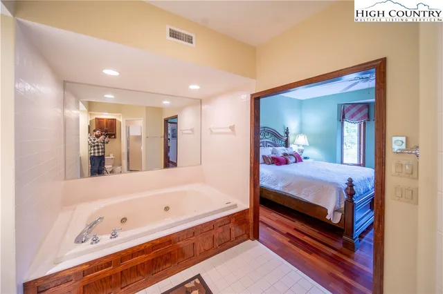 a bed room with a bed and a large mirror