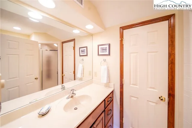 a bathroom with a sink a mirror and a shower