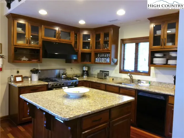 a kitchen with a sink a stove and cabinets