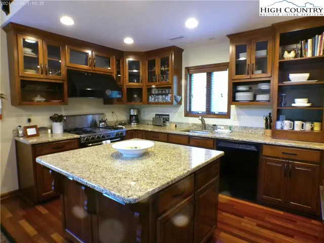 a kitchen with a stove center island and cabinets
