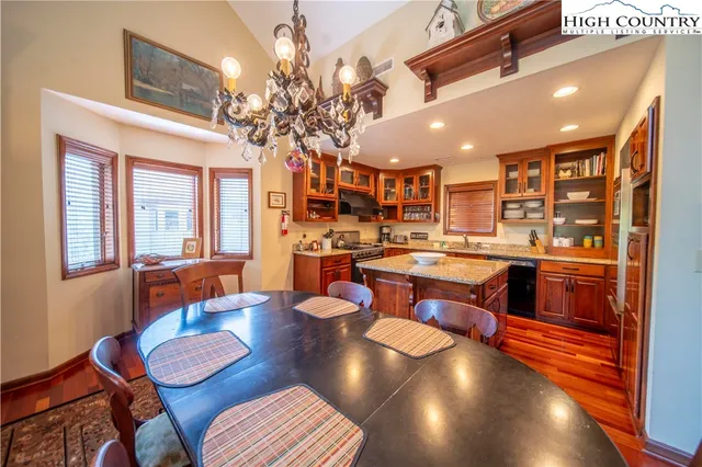 a large kitchen with a table and chairs