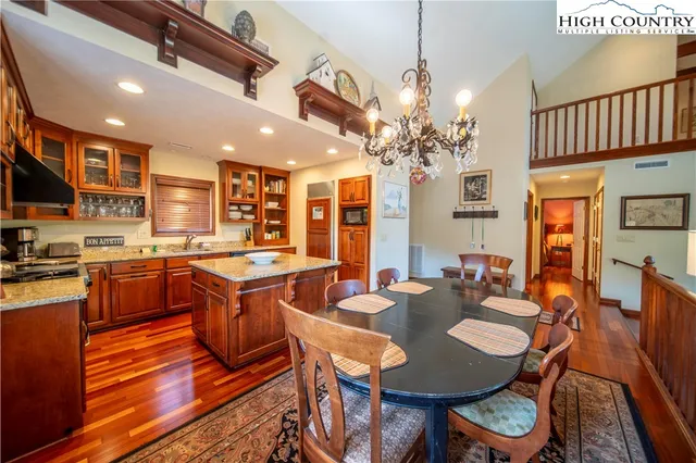 a large kitchen with a table and chairs