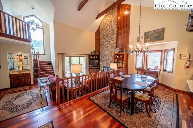 a dining room with furniture a rug and wooden floor