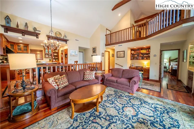a living room with furniture a rug and a chandelier