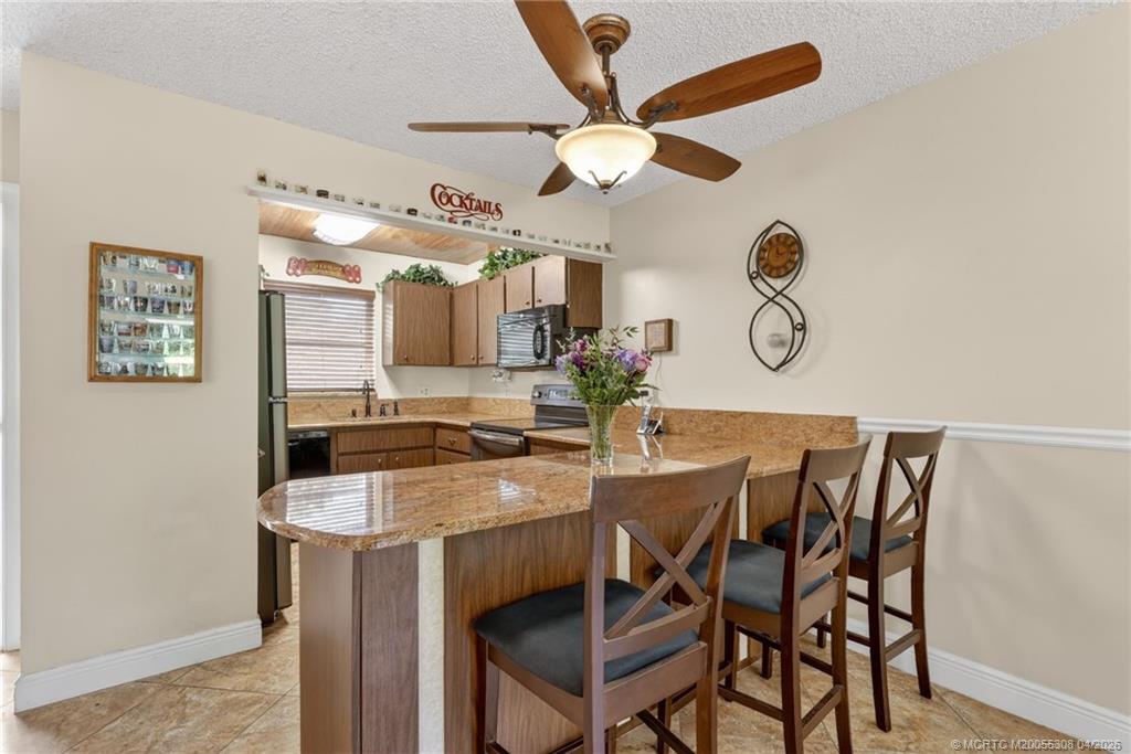 330 Southwest Winnachee Drive Stuart, FL 34994 - Photo 11 of 49 Granite countertops, convenient peninsula seating.