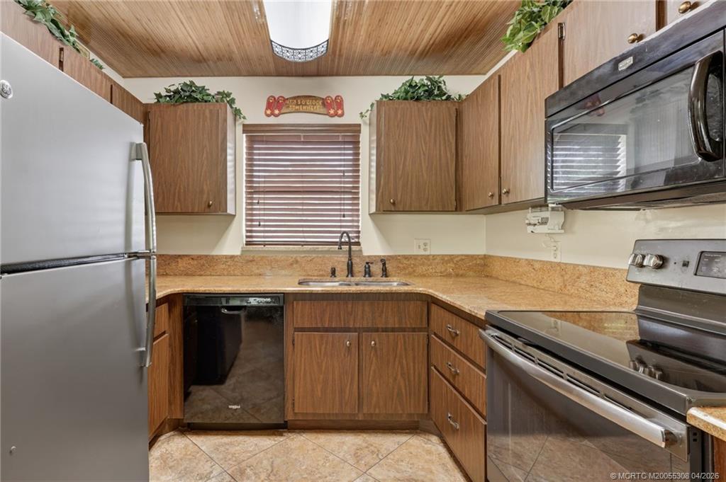 330 Southwest Winnachee Drive Stuart, FL 34994 - Photo 13 of 49 Granite countertops, large square tile flooring.